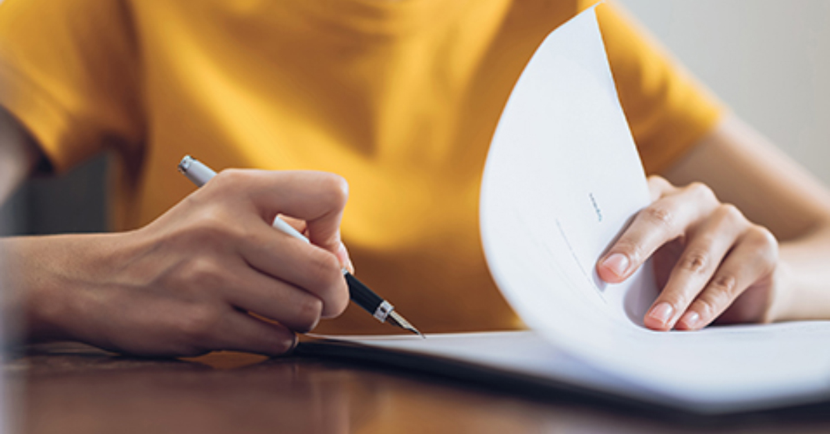 Woman signing paperwork