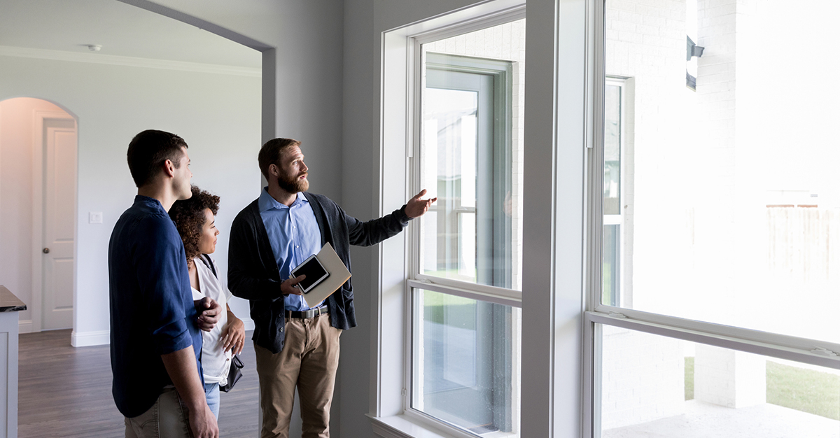 An agent shows a couple a home