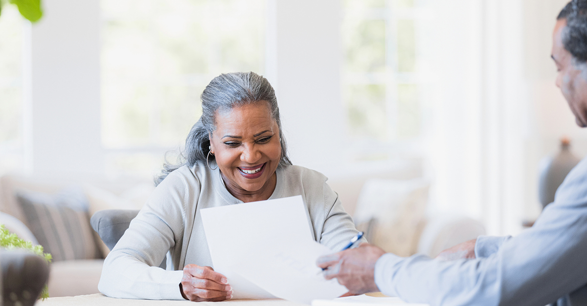 A happy women looks at her statement of information