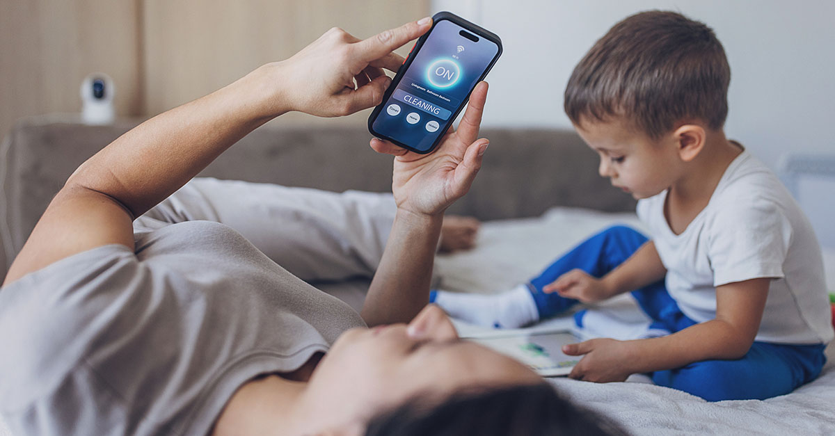 A mom using her smartphone to adjust the AC