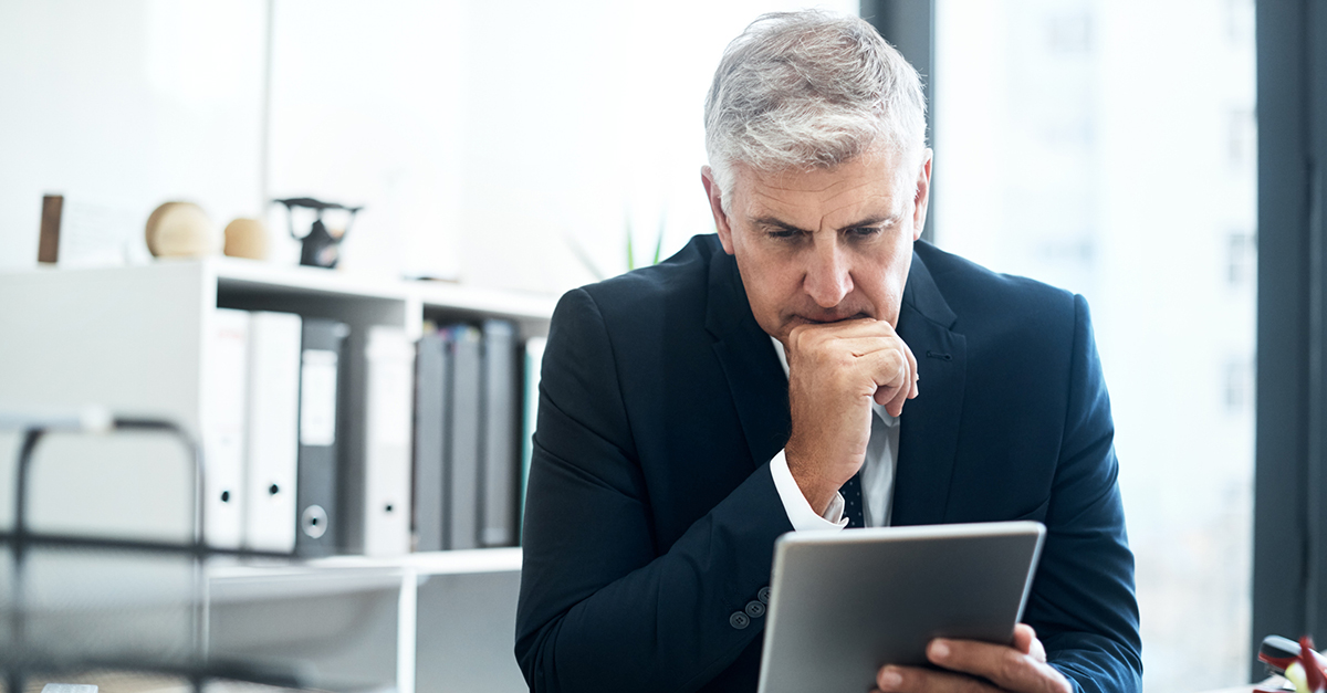 A businessman reading the news on his tablet