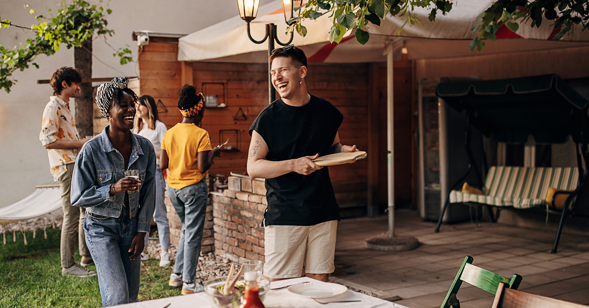 A group of friends gather for dinner on a patio